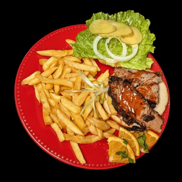 Charlie Staples Pitt Boss BBQ plate with fries, BBQ ribs, lettuce, pickles, onions, and orange slices.